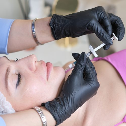detailed view of a hyaluronic acid injection procedure, focusing on the chin area. experiences or